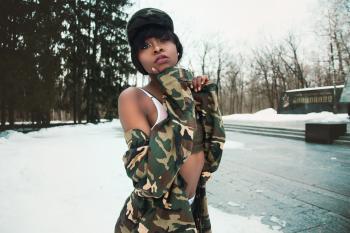Woman Wearing Camouflage Shirt Covered by Snow