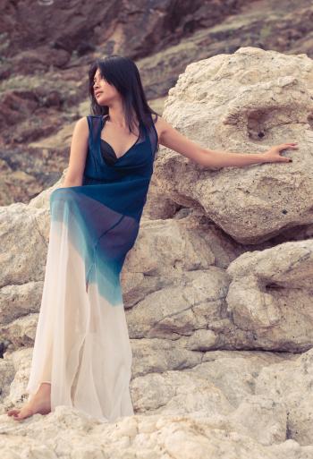 Woman Wearing Dress Standing on the Rock