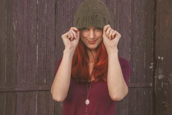Woman Wearing Maroon Scoop-neck Shirt With Brown Knit Cap