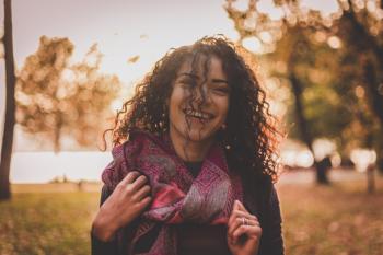 Woman Wearing Pink and Grey Scarf Smiling