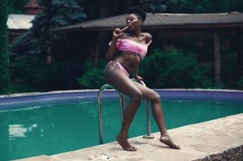Woman Wearing Pink Bikini Set Beside Swimming Pool