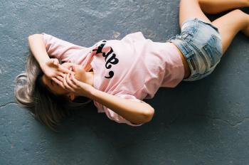 Woman Wearing Pink Printed Crew-neck T-shirt and Blue Faded Denim Shorts