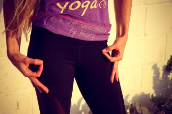 Woman Wearing Purple and White Yoga Printed Shirt and Black Bottoms