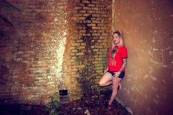 Woman Wearing Red Crew-neck Sleeved Shirt and Blue Denim Short Shorts
