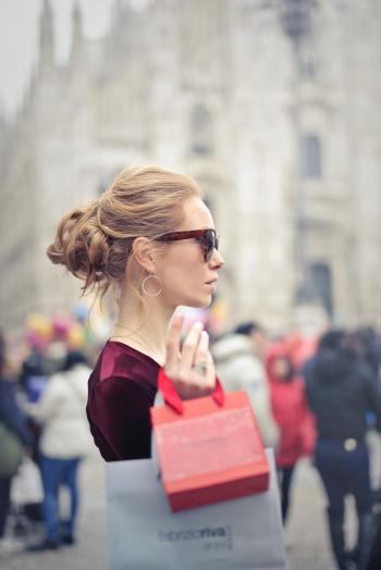 Woman Wearing Red Top Carrying Red Paper Tote Bag