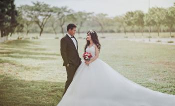 Woman Wearing Wedding Dress Standing Beside a Man Wearing Tuxedo