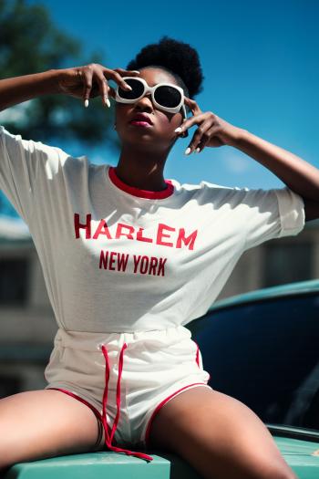 Woman Wearing White and Red Harlem New York Printed Round-neck Batwing-sleeved Shirt With Drawstring Dolphin Shorts