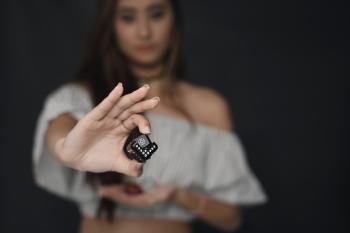 Woman Wearing White Off-shoulder Crop Top Holding Black Cube