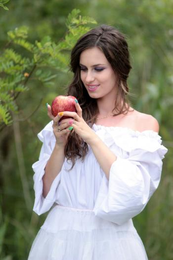Woman Wearing White Off Shoulder Top Holding Red Apple Fruit