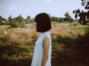 Woman Wearing White Sleeveless Dress Near Brown Grass Field
