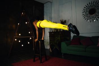 Woman Wearing Yellow Pants Doing Yoga Exercise