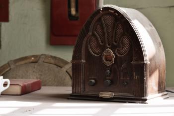 Wooden retro radio on a table in an old room