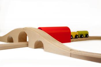 Wooden toy train on railroad