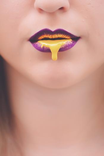 Yellow Liquid on Woman's Lips