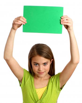 Young girl holding a blank green sign