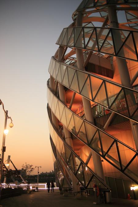 2 Person Walking Beside Dome Shape Designers Building