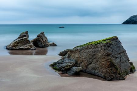 3 Brown Boulders on Seashore during Daytime