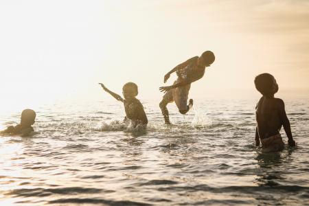 4 Person Playing in Ocean during Daytime