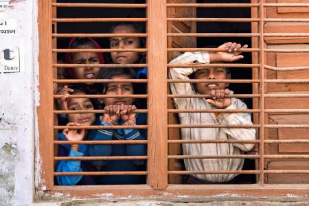 5 People Leaning on Brown Railings of Window