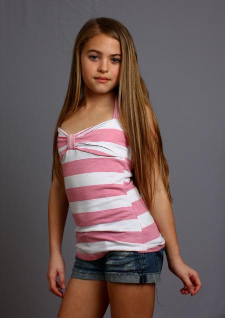 A beautiful young girl posing on gray