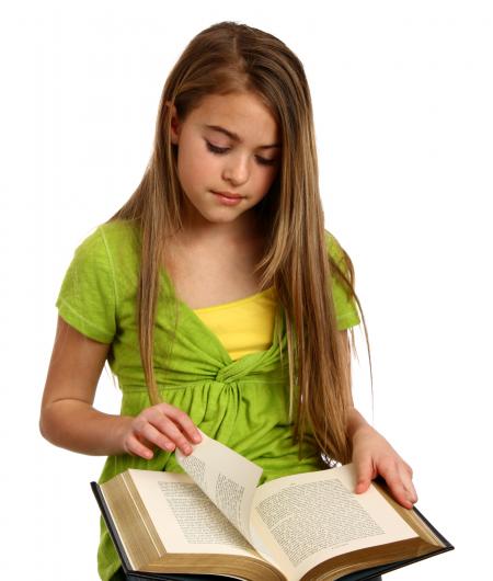 A beautiful young girl reading a book