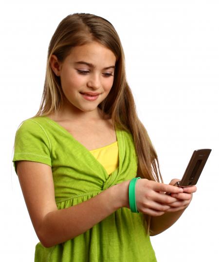 A beautiful young girl texting on a cell