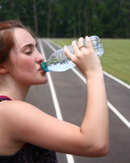 A cute young girl drinking water