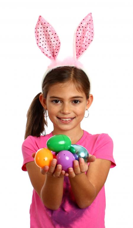 A cute young girl holding Easter eggs