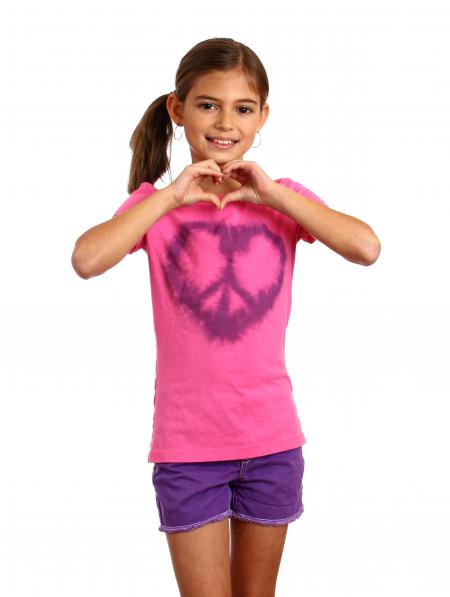 A cute young girl making a heart symbol