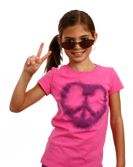 A cute young girl making a peace symbol