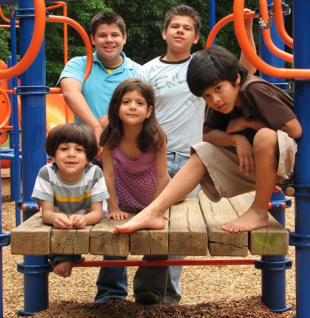A group of kids posing on a playground