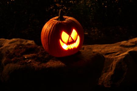 A Halloween jack-o-lantern on a rock