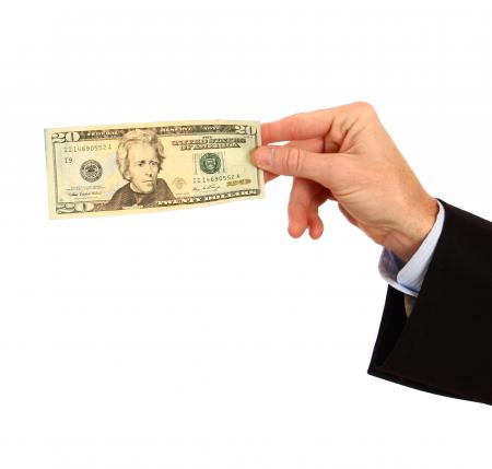 A hand holding a twenty dollar bill