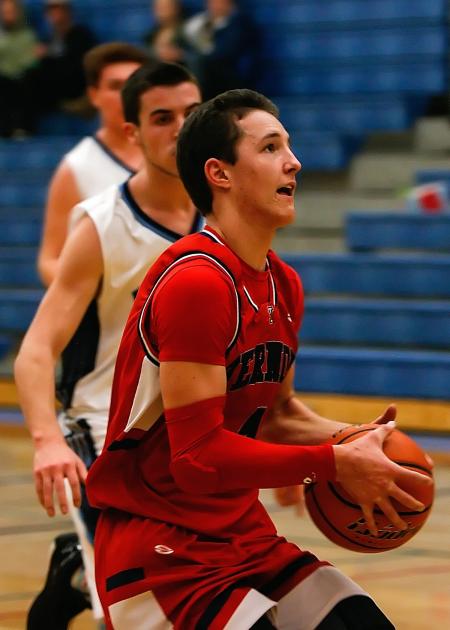 A Man Wearing Red Jersey Carrying an Orange Basketball