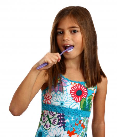 A pretty young girl brushing her teeth