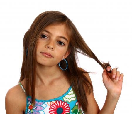 A pretty young girl pulling on her hair
