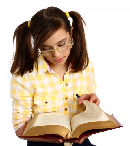 A smart girl with glasses reading a book