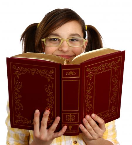 A smart girl with glasses reading a book
