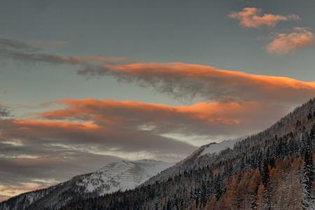 A View of Snowy Mountains Under Cloudy Sky