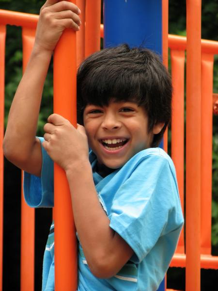 A young boy playing on a playground