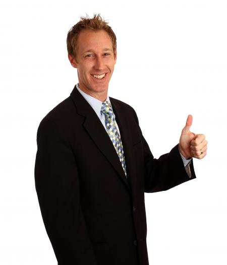 A young businessman giving a thumbs up