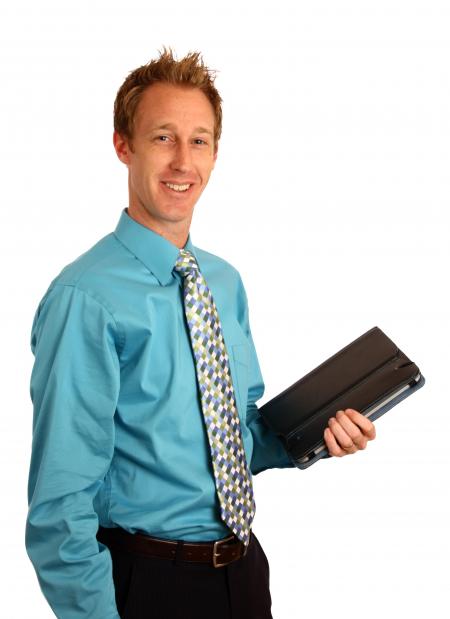 A young businessman holding a binder