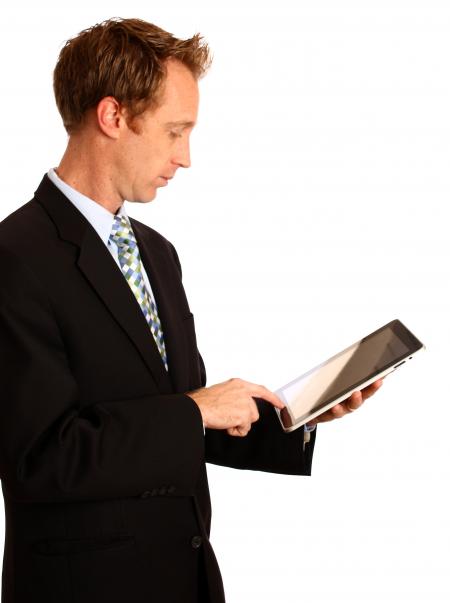 A young businessman holding a tablet com