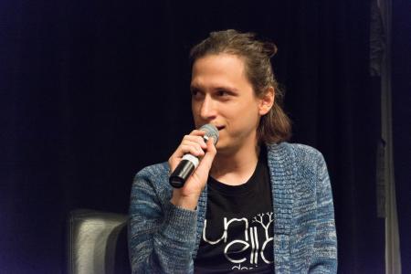 Aaron Lemke (Unello Design) discussing at indie dev panel at SVVR (microphone at mouth looking stage right)