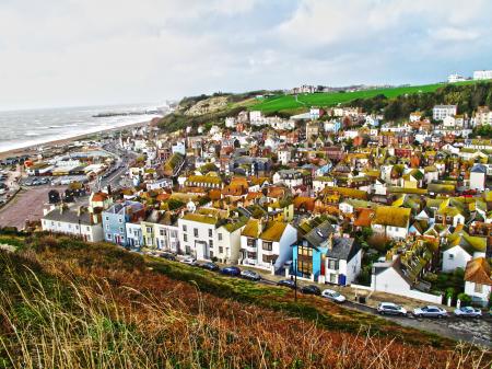 Aerial Photography of Brown Roofed Houses Near Sea