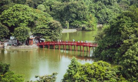 Aerial Photography of People Crossing Bridge over Body of Water