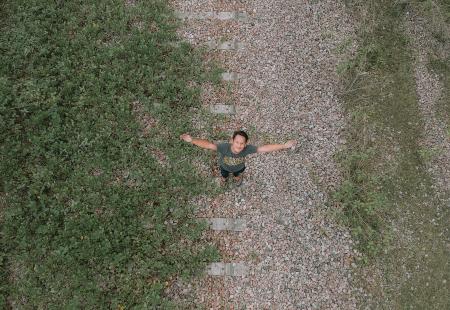 Aerial View Of Man In Grey Top And Black Pants Standing