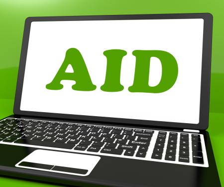 Aid On Laptop Shows Assisting Aiding Help Or Relief