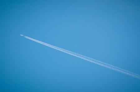 airplane flying through blue sky