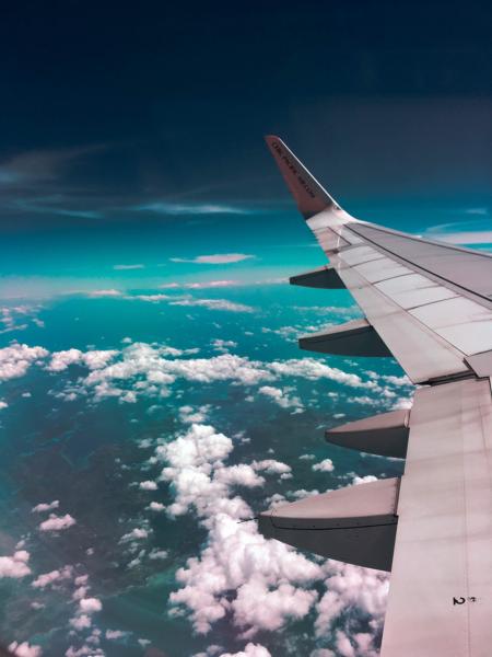 Airplane Wing Towards Clouds